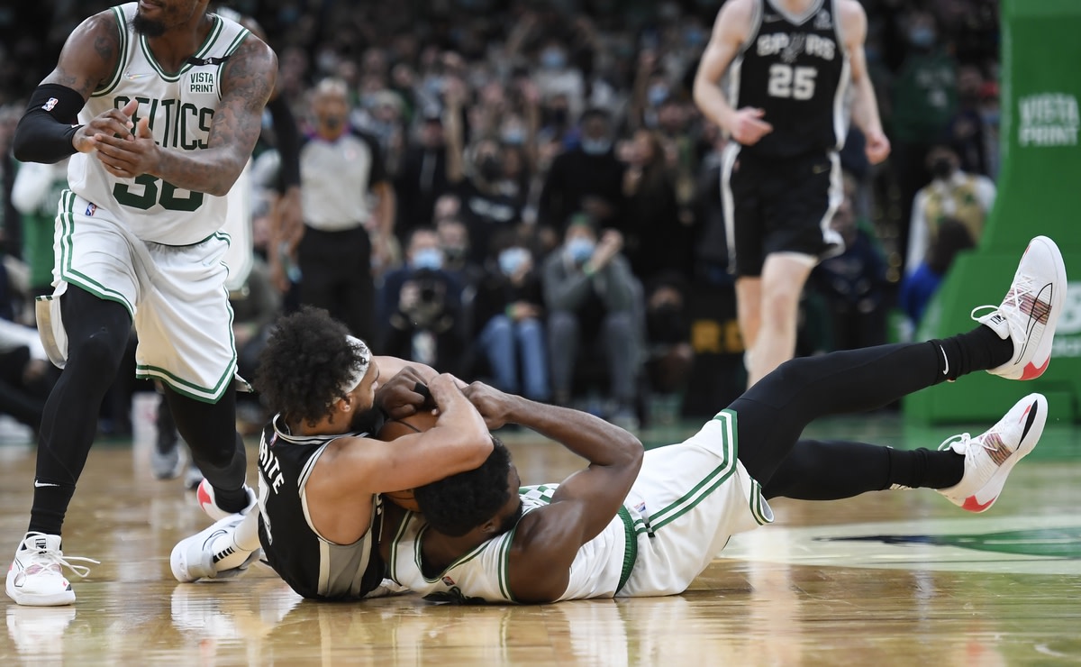 Derrick White fights for a loose ball against the Boston Celtics